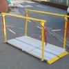 made by planet platforms (Wakefield) the cross transfer ramp is shown deployed, handrails detach and ramp folds in two with carrying handle.